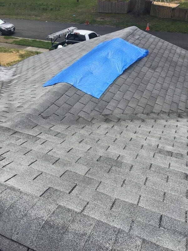 Asphalt shingle roofing being repaired