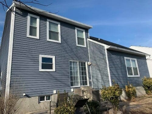 New blue siding with white trim on home