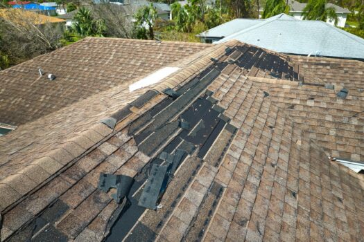damaged residential roof that has been damaged by a storm